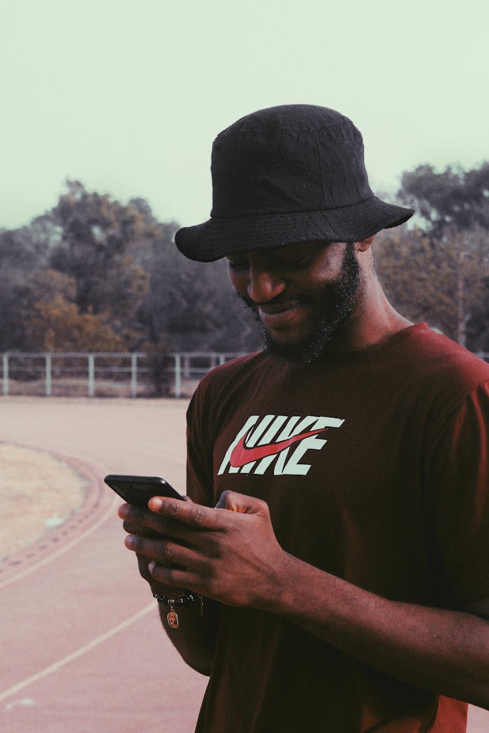 Black man messaging on smartphone